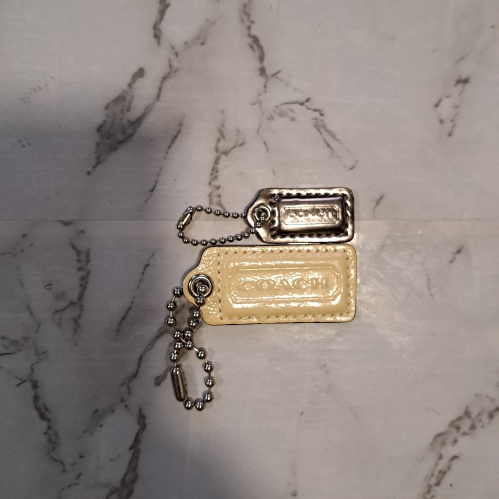 Coach key tags, bag charms silver and cream